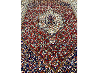 Rug with a red pattern and blue border, central medallion with ornaments