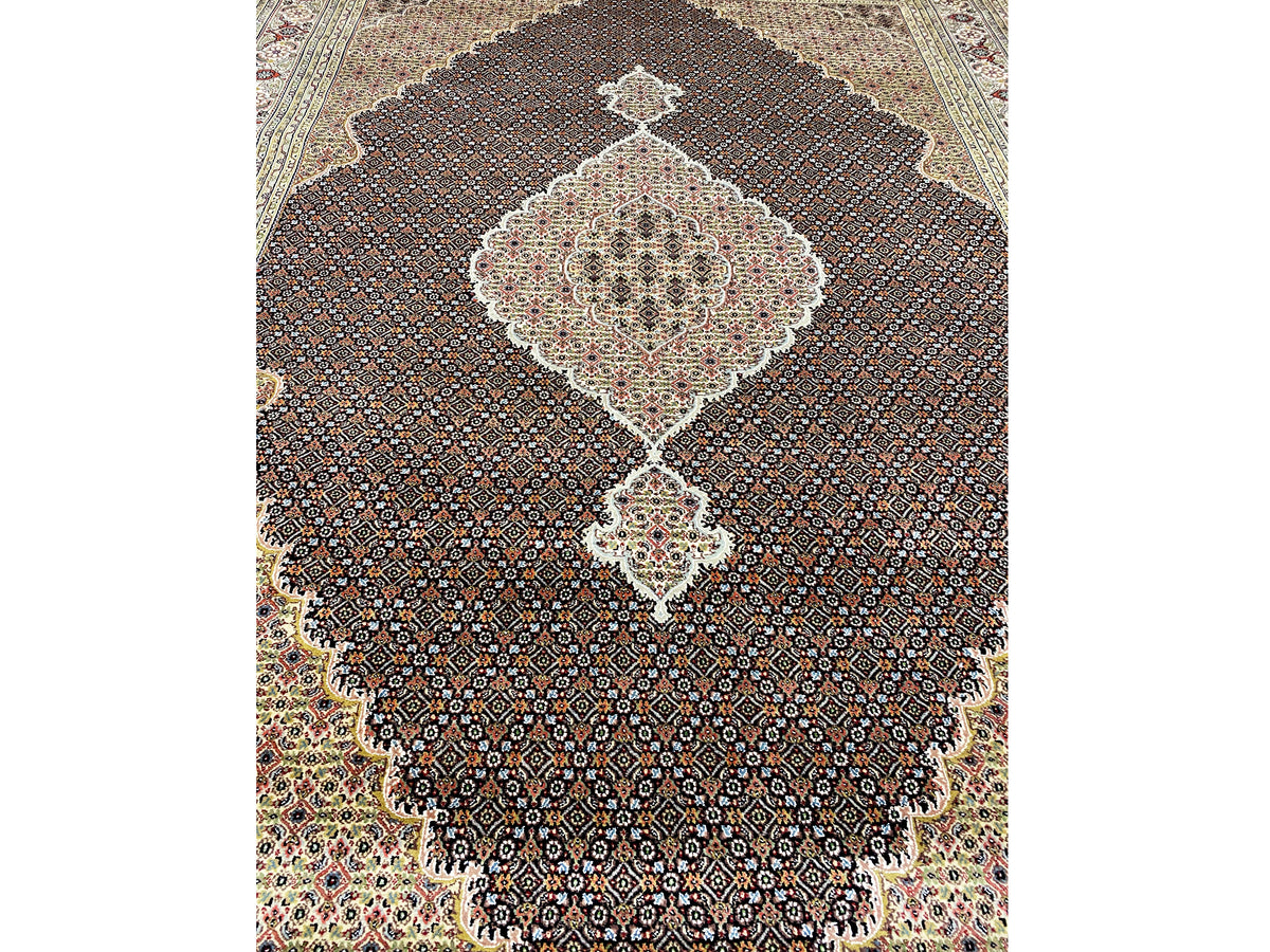 Close-up: beige and dark brown carpet medallion with a lively pattern, lower section