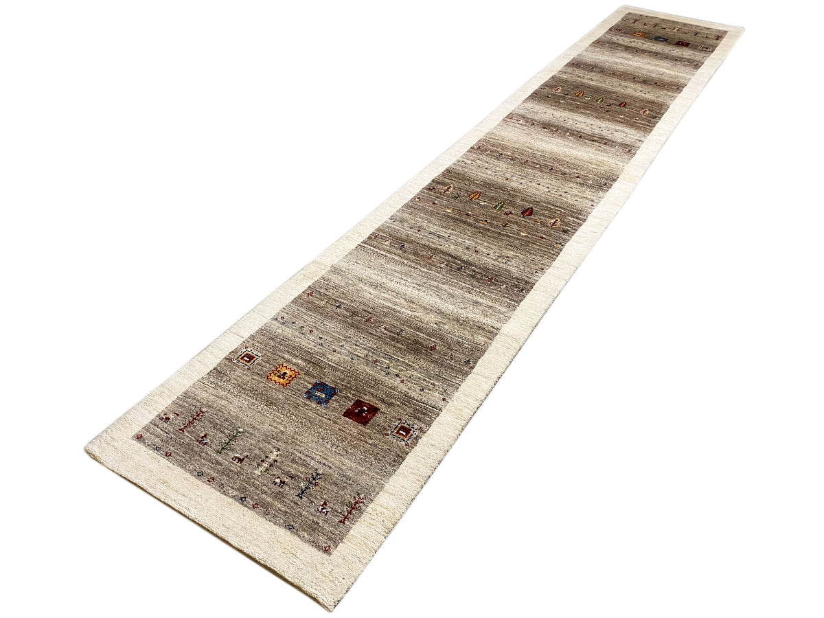 Gabbeh runner rug, lengthwise view: mottled gray, light border edge, small ornaments.