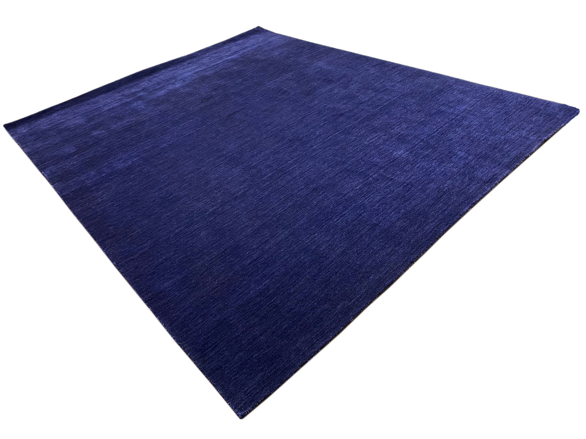 Blue carpet in a diamond view with an even, finely textured pile.