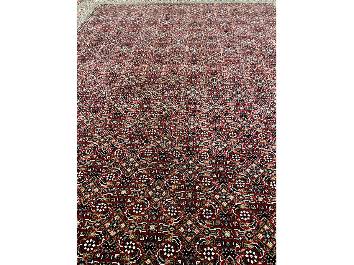 Close-up of a Bidjar rug: dense ornamental pattern in dark red, black, and colorful accents
