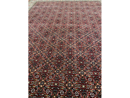 Close-up of a Bidjar rug: dense ornamental pattern in dark red, black, and colorful accents