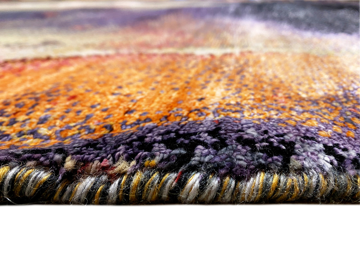 Designer rug close-up of the border: high-pile texture with a multicolored edge and fringes.