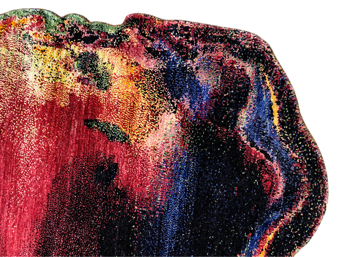 Carpet detail view: Lustrous pile with red, yellow, green, and blue in abstract zones