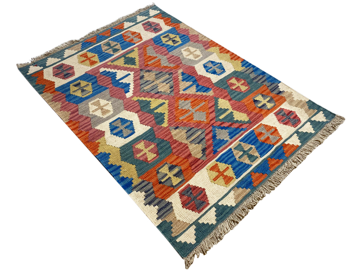 Qashqai rug laid diagonally: multicolored patterns on a blue background