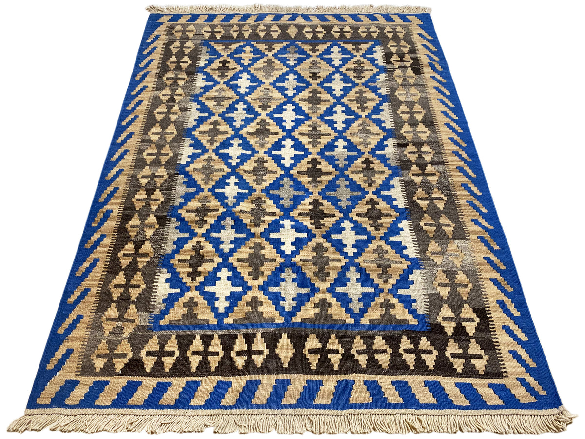 Rectangular kilim rug with a border, blue central motif, and fringes