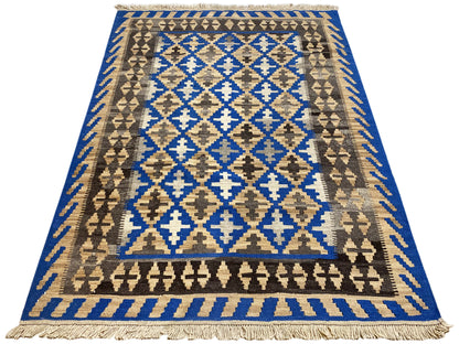 Rectangular kilim rug with a border, blue central motif, and fringes