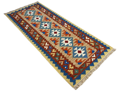 Narrow rectangular kilim rug, pattern in blue, brown, red and white on a beige background
