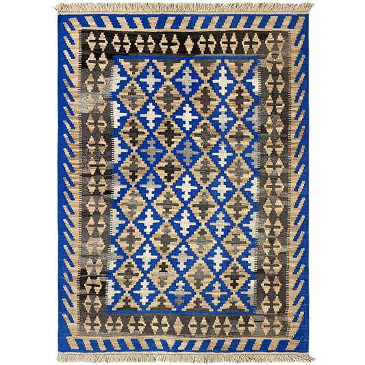 Kilim rug with a blue central field, beige and brown diamond patterns, and fringes