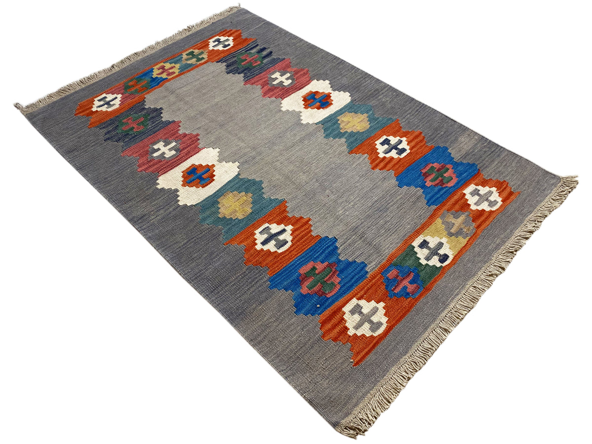 Gray marled Kilim rug with diagonally arranged colorful symbols and fringes