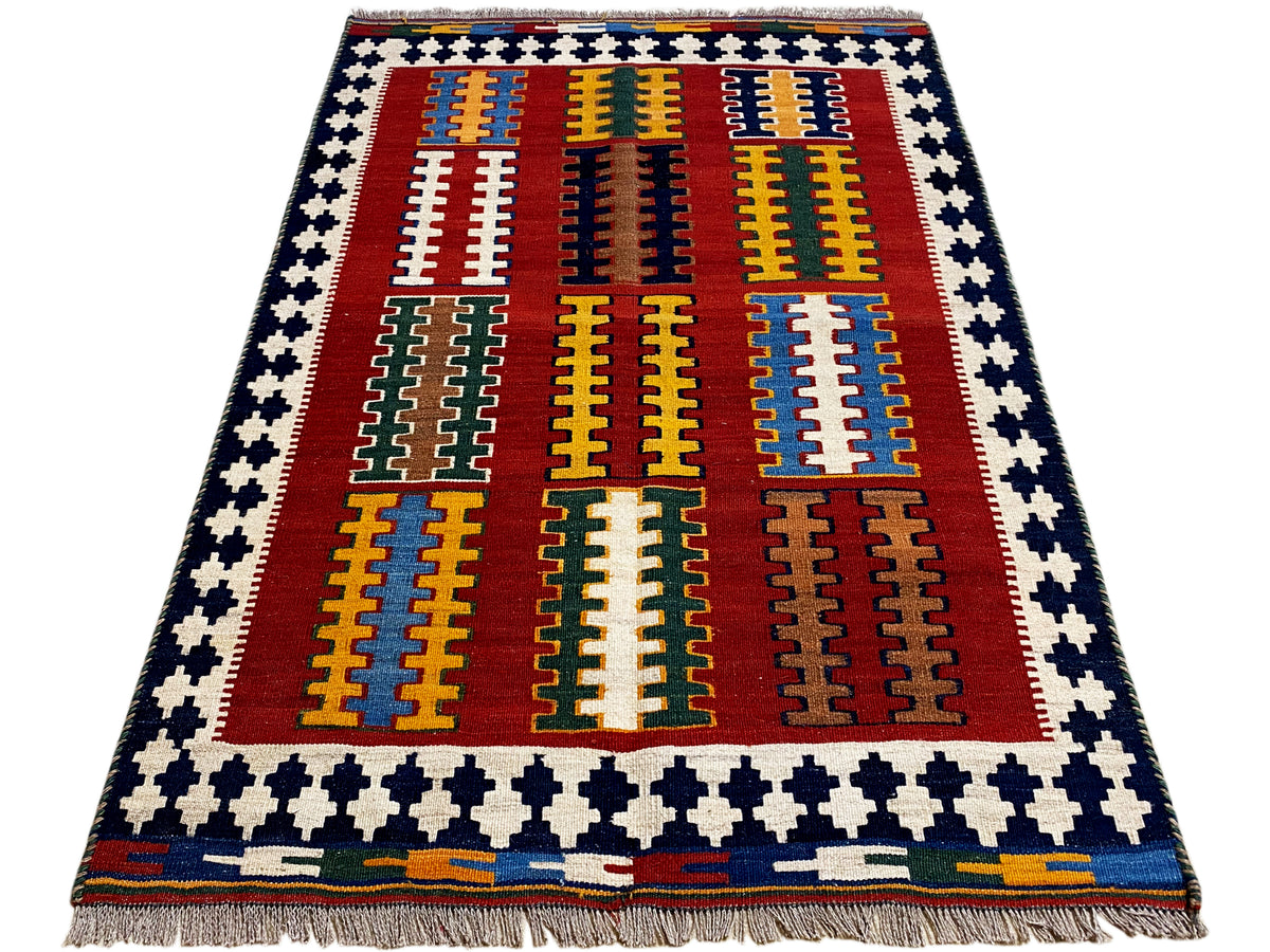 Kilim rug with a red central field, yellow-blue stripes, and a blue-and-white border frame, fringes