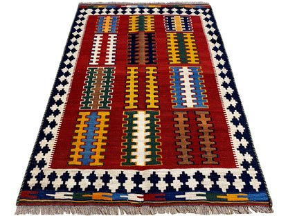 Kilim rug with a red central field, yellow-blue stripes, and a blue-and-white border frame, fringes
