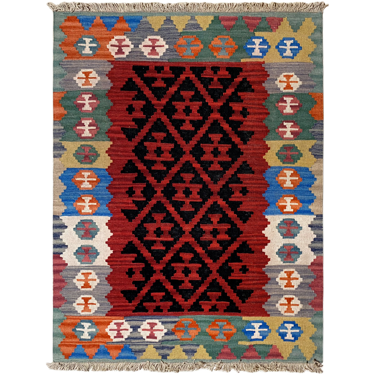 Kilim rug with a broad central black-on-red pattern, decorative stripes, and fringes