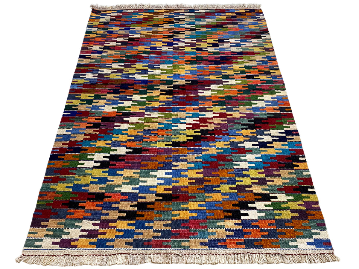 Flat-woven Kelim Qashqai rug with a colorful grid pattern and fringes all around