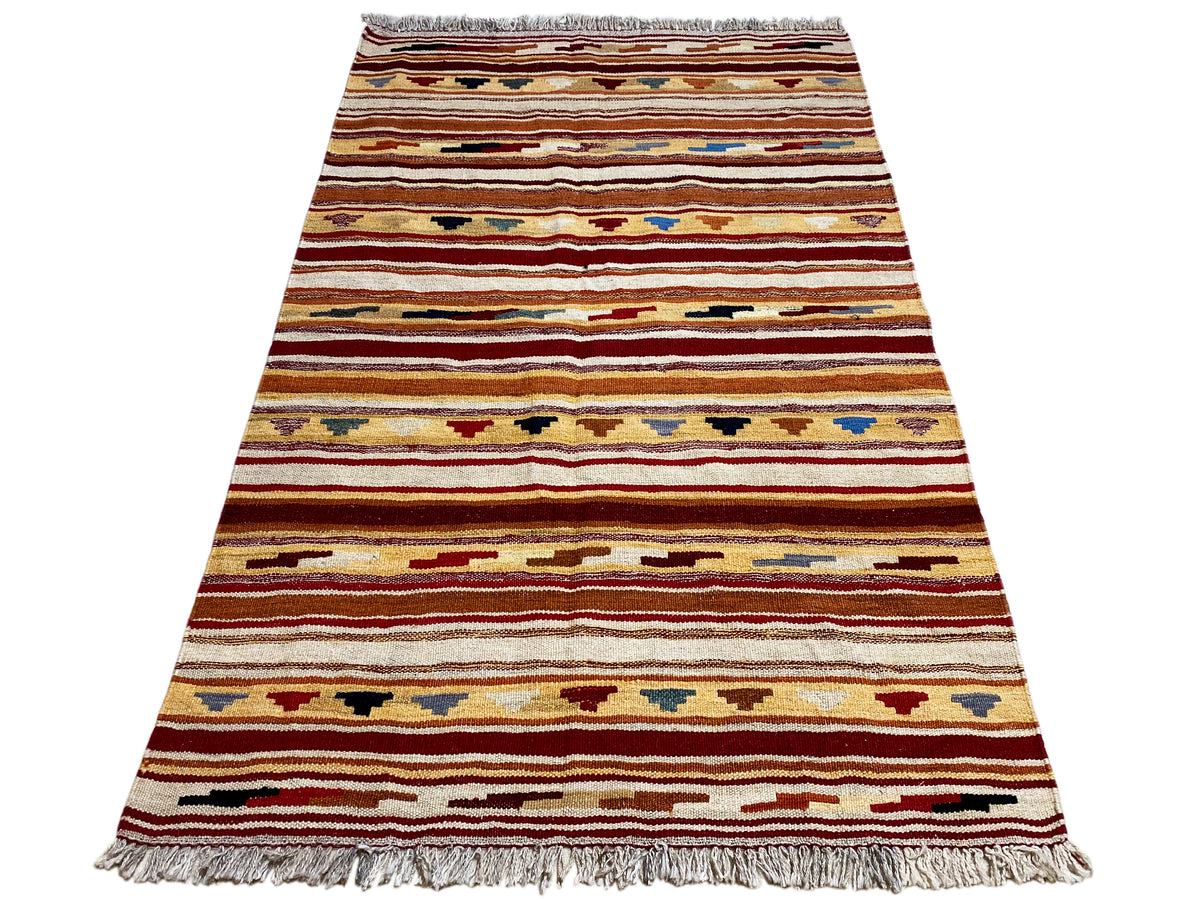 Narrow-oriented kilim rug: multicolored stripes and fringes along the bottom edge