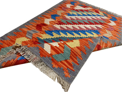 Kilim Qashqai rug with a zigzag pattern, colored stripes, and fringes along the edge, 121x78 cm