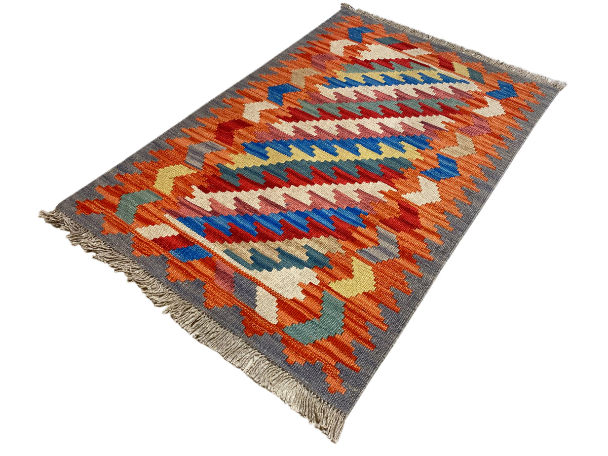Kelim Qashqai rug, all-over chevron pattern in orange, blue, green, and white, 121x78 cm