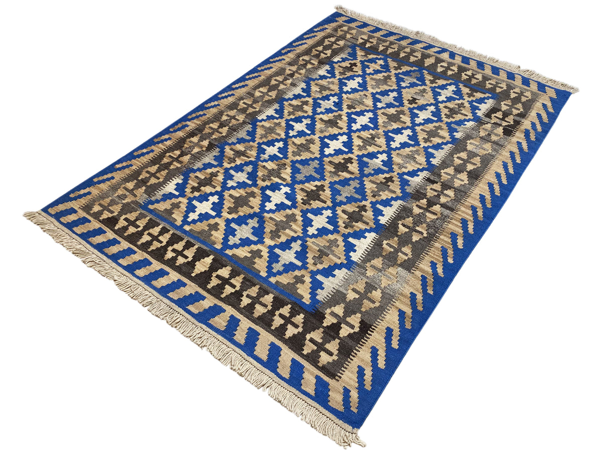 Angled kilim rug with a blue-and-beige pattern and fringes on all corners