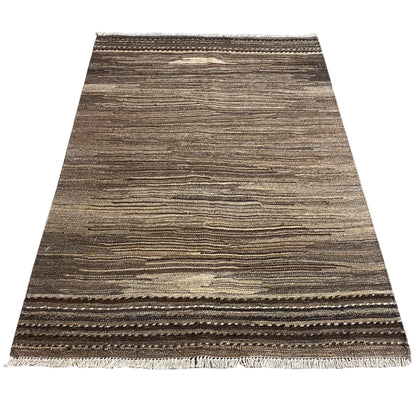 Brown and beige kilim rug with a border around the edges and fringes