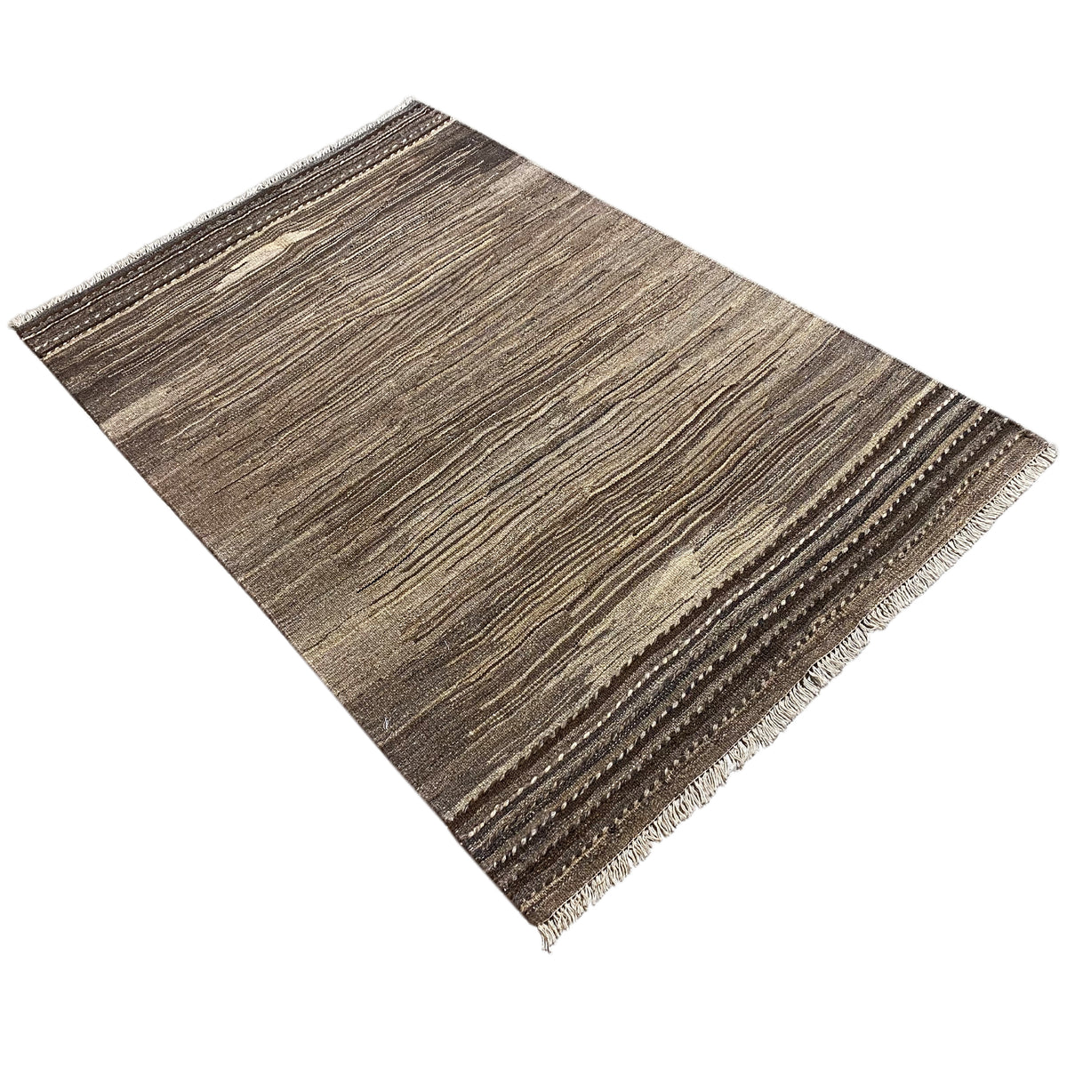 Kilim rug positioned at an angle: brown and beige wavy stripe pattern, fringed edge