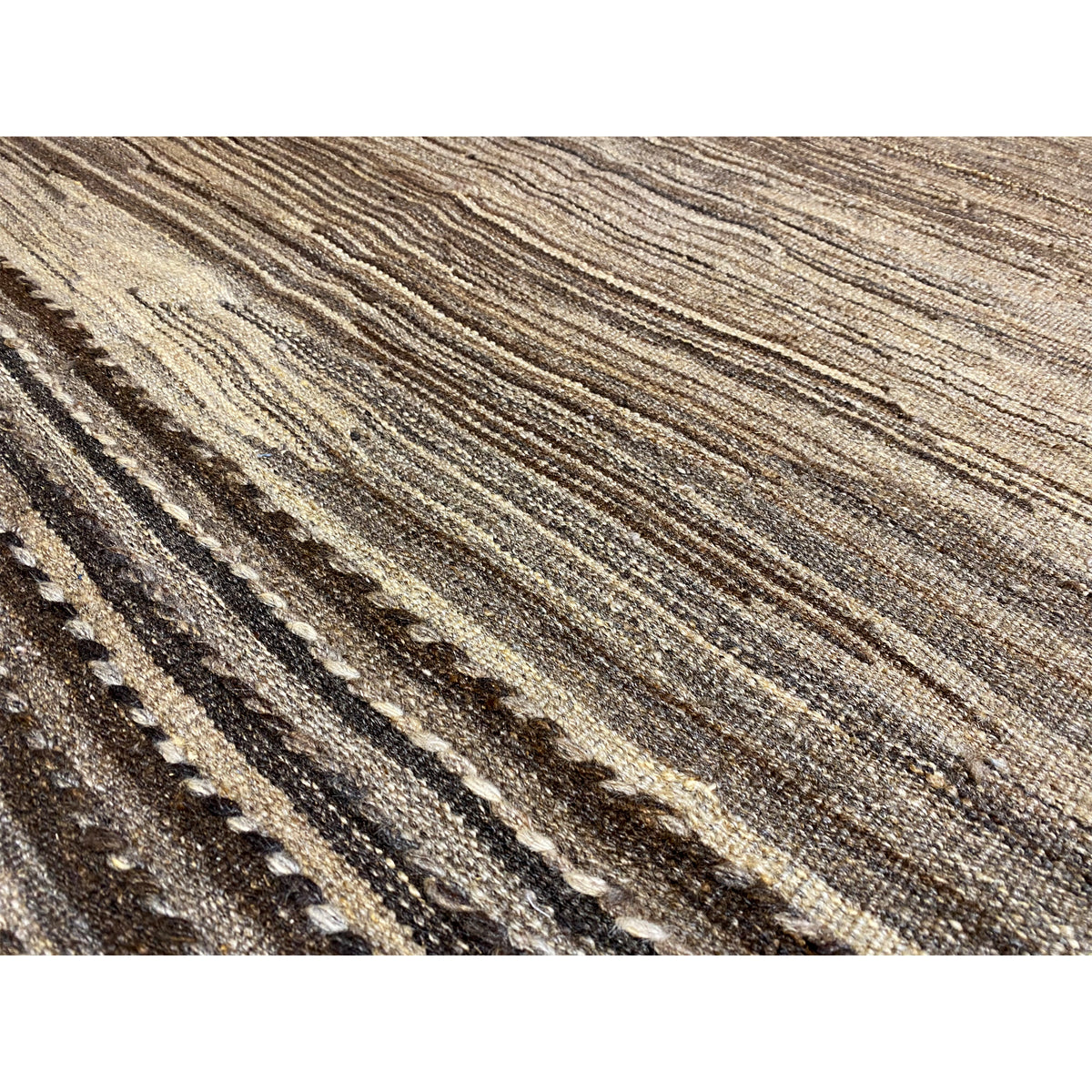 Close-up: brown-beige kilim fabric with fine lines and cool shades
