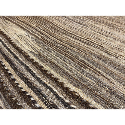 Close-up: brown-beige kilim fabric with fine lines and cool shades