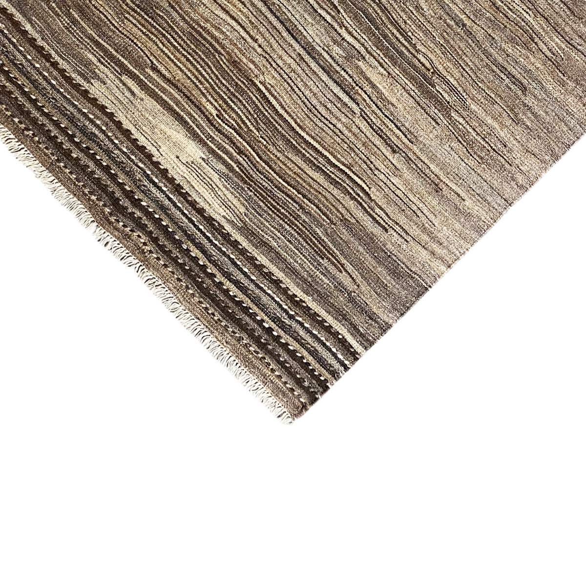 Close-up detail of the edge: brown and beige kilim stripe with fringes