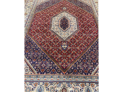 Close-up: red medallion in dark blue with white patterned corners and border at the bottom
