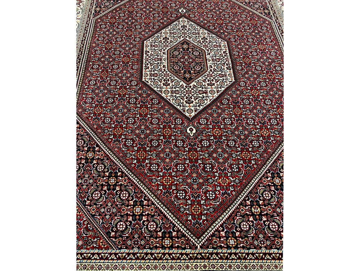View of the red carpet with a central medallion and diagonal ornamental frames