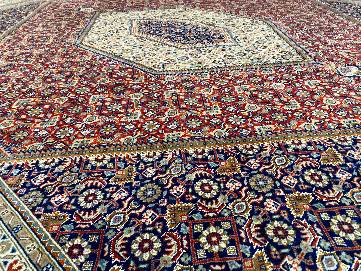 Bidjar rug with a red background and colorful floral and diamond pattern, large-scale details