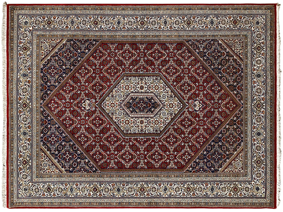 Carpet with a red central medallion, wide border in beige, blue, and dark red