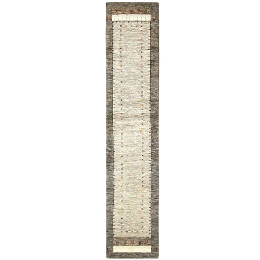 Narrow Gabbeh runner rug viewed from the front, even dotted pattern on a light background