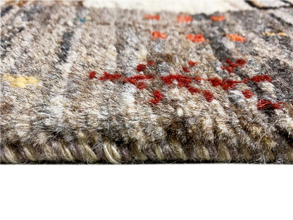 Gabbeh runner rug detail: dense pile with orange-red color details and dark accents