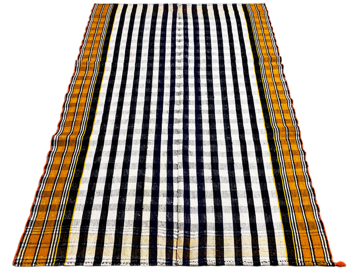 Rectangular Jajim rug with a black-and-white striped grid and yellow-orange border edge