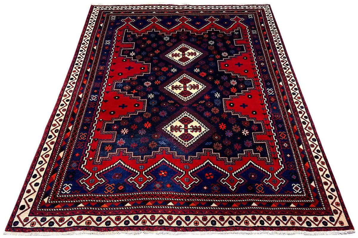 Rug 232x171 cm with a dark blue base, red accents, and a central diagonal motif
