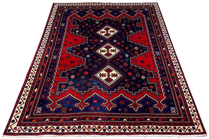 Rug 232x171 cm with a dark blue base, red accents, and a central diagonal motif