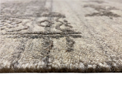 Close-up: Gray designer rug with a dense pile and a faded pattern