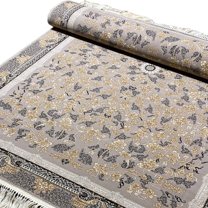 Rolled-up carpet, gray background with golden floral ornaments and a dark border