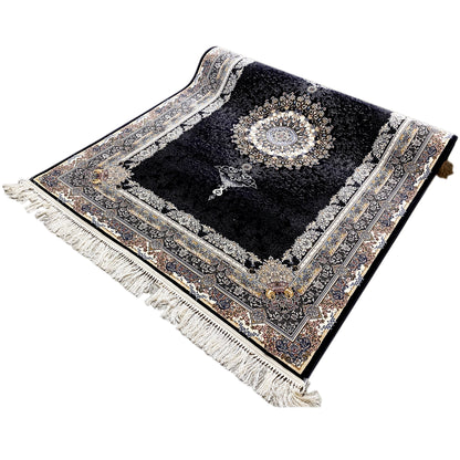 Three-quarter view: black rug with medallion pattern, border, and fringe