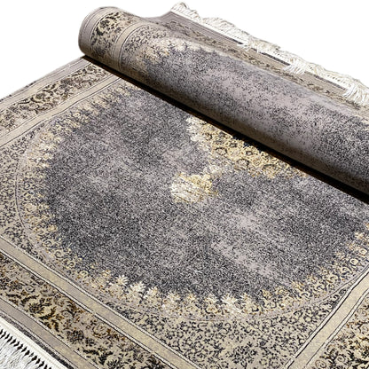 Medallion and border rug, mottled gray, gold patterns, fringed edges