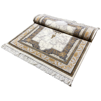 Rolled-out rug: cream-colored base with gold-gray borders and fringes along the edge.