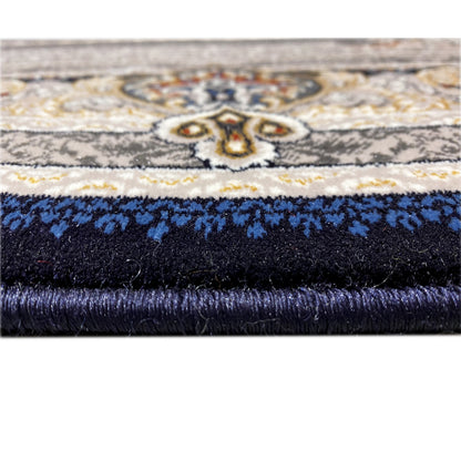 Carpet edge in detail: fringe at the top, dark pile, and blue ornamental band