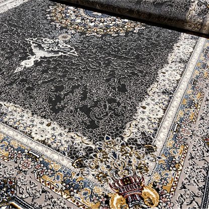 Oriental rug in dark gray/black with a light ornamental medallion and decorative borders