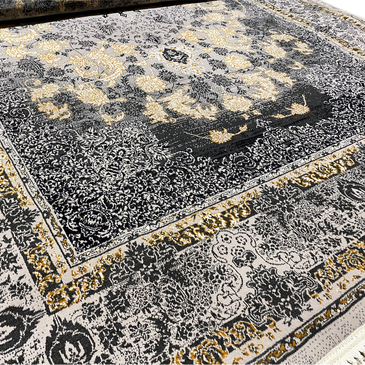 Rug detail: dark medallion, floral ornaments, golden accents, fringed edge