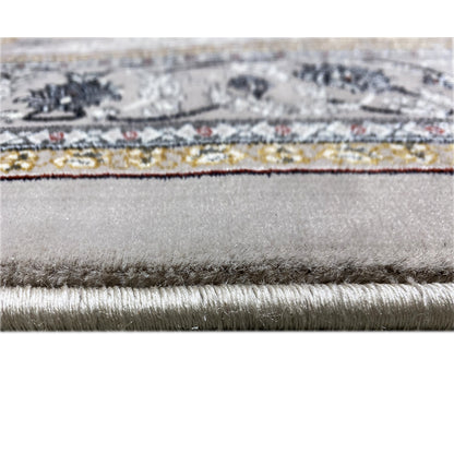 Close-up of the carpet edge with fringe and fine fibers, gray mottled fabric