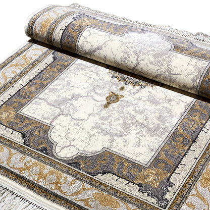 Rug detail: bordered cream-colored area with gold accents and fringe trim.
