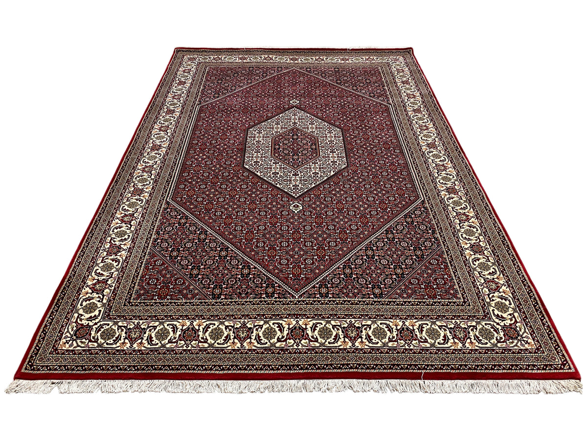 Bidjar rug viewed from above with a red background, cream-colored border, and central medallion