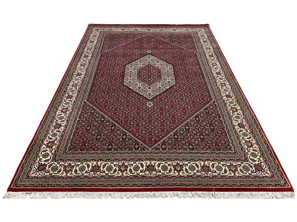 Bidjar rug viewed from above with a red background, cream-colored border, and central medallion
