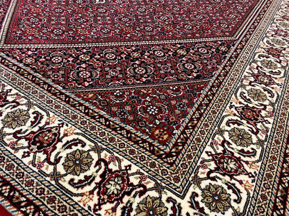 Pattern details: red carpet with framed ornaments and a border