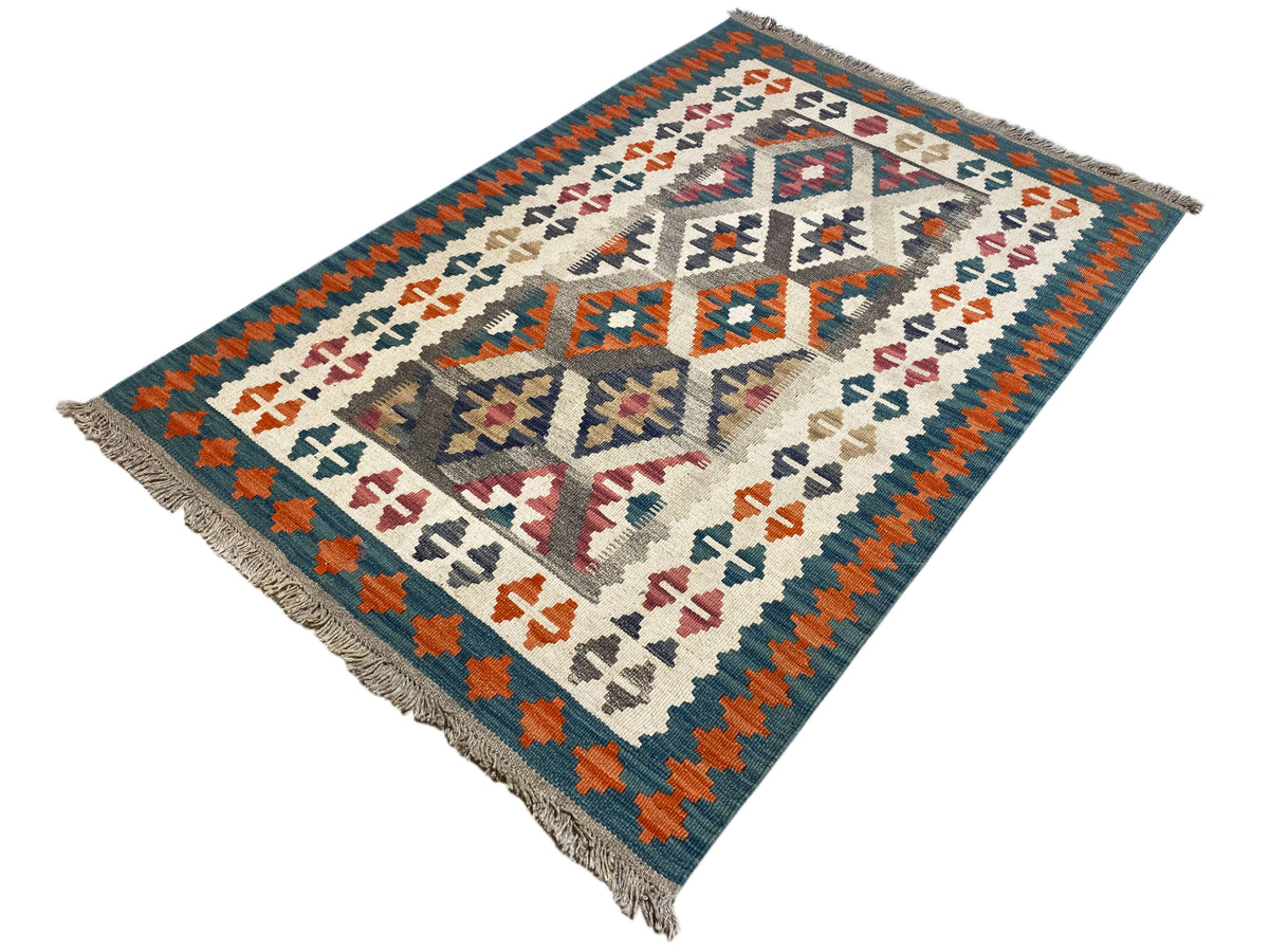 Kilim rug with a centered diamond design and colorful symbols, fringes at the corners